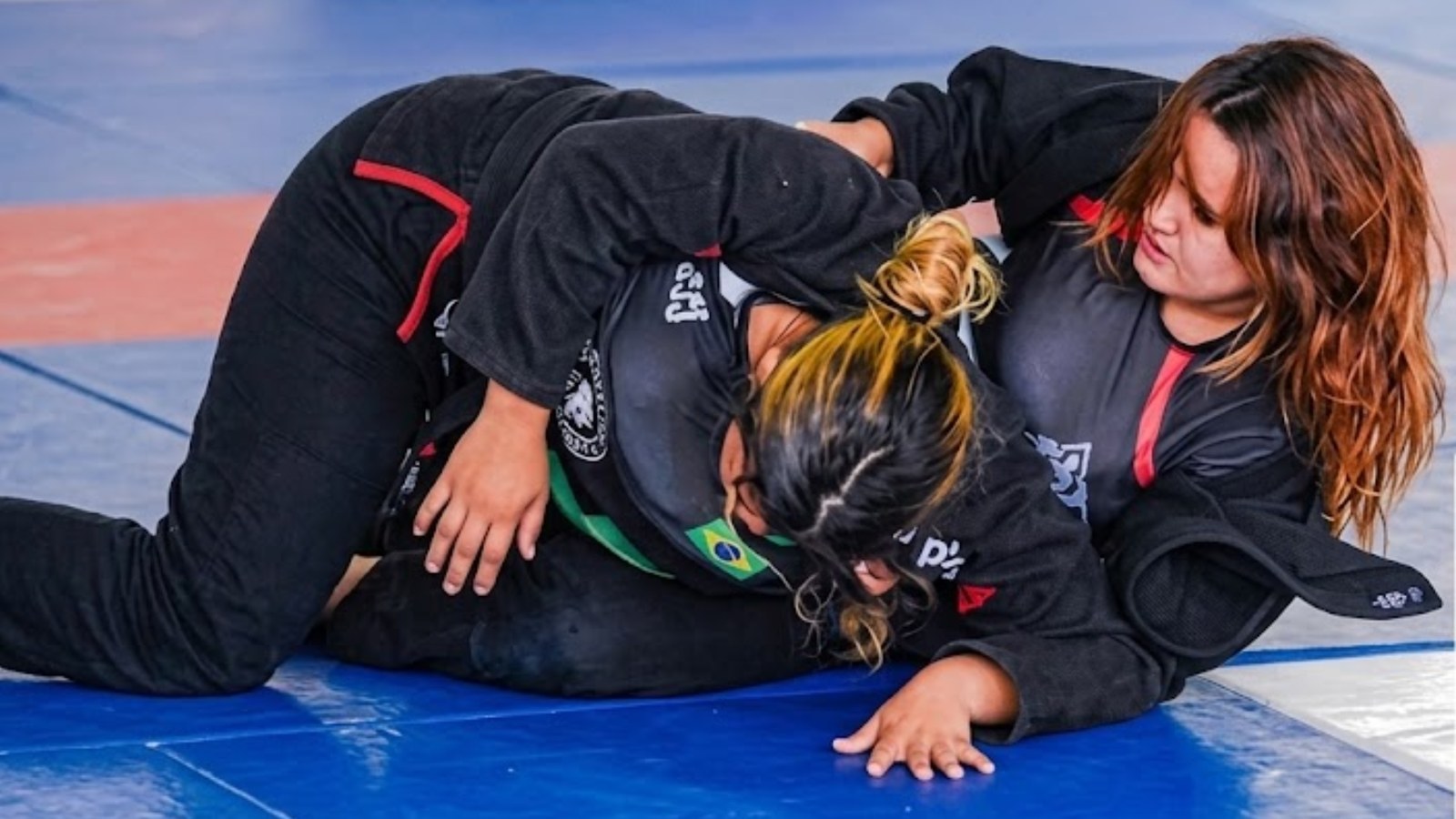 Alunas treinando jiu-jitsu no tatame do CT Tarcísio Alves, ambiente familiar e supervisionado